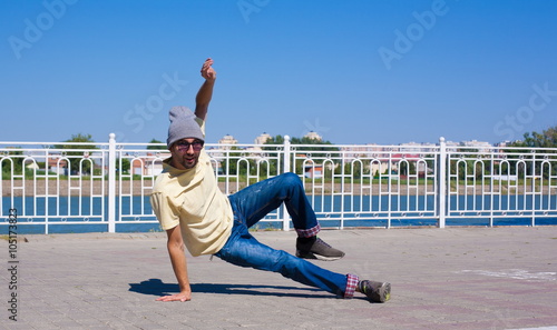 Sergey Pustovoyt. Man dancing yellow shirt blue jeans sunglasses