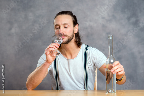 Принти на полотні young man drinking clear spirit