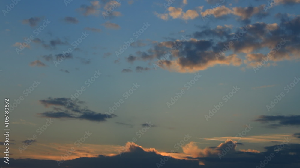Timelapse sunset with orange,blu,grey, puffy clouds against the blue sky, day become night Timelapse sunset with orange,blu,grey, puffy clouds against the blue sky, day become night