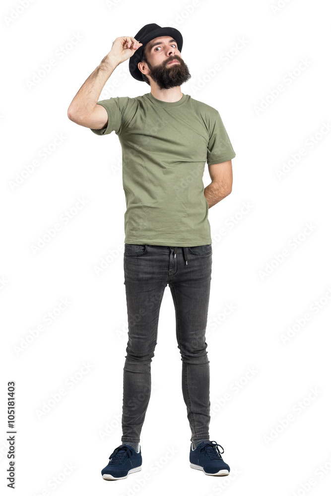 Man adjusting hat with head leaned back staring intense at camera. Full body length portrait isolated over white studio background. Man adjusting hat with head leaned back staring intense at camera. Full body length portrait isolated over white studio background.