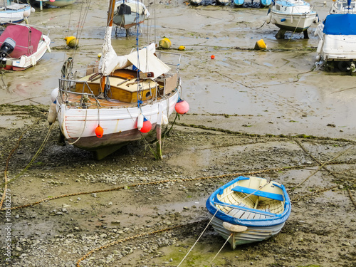 Yachts in a harbour during outflow. Harbour Saint Aubin, Jersey island, Channel Islands photo