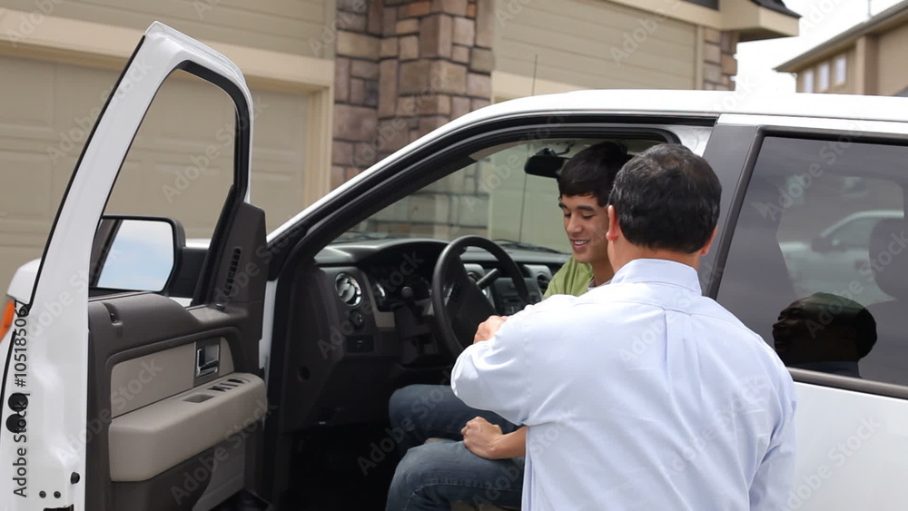 Father congratulates son as he gets into new truck Father congratulates son as he gets into new truck