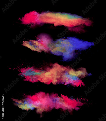 Explosions of colored powder on black background