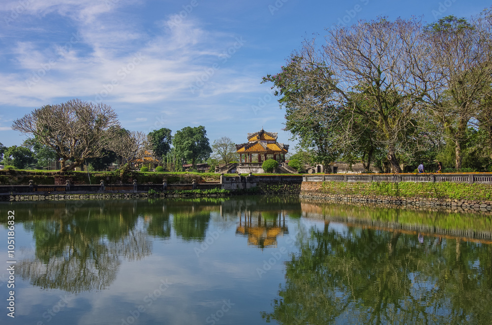 Pavilion and pond with reflection in the royal forbidden city, Hue, Vietnam