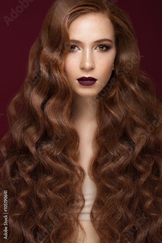 Beautiful brunette girl with a perfectly curls hair and classic make-up. Beauty face. 