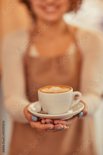 Nice woman holding cup of coffee