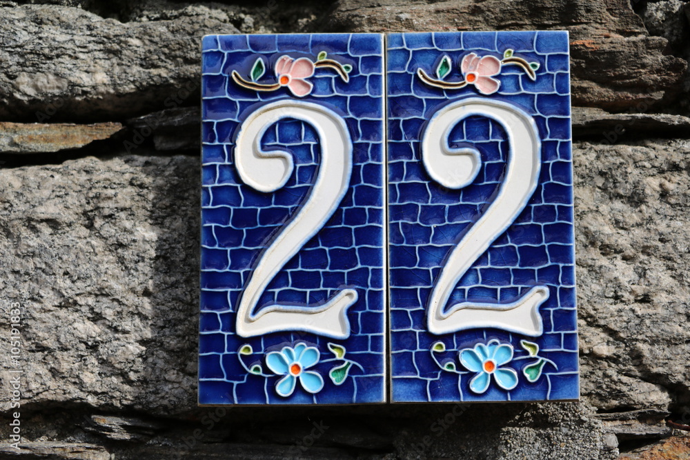 Fototapeta premium house number twenty two at old stone wall 
