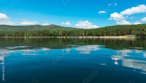 Russia. The Southern Urals. Lake Turgoyak.  Clouds reflected on the water surface of the lake in clear weather.  