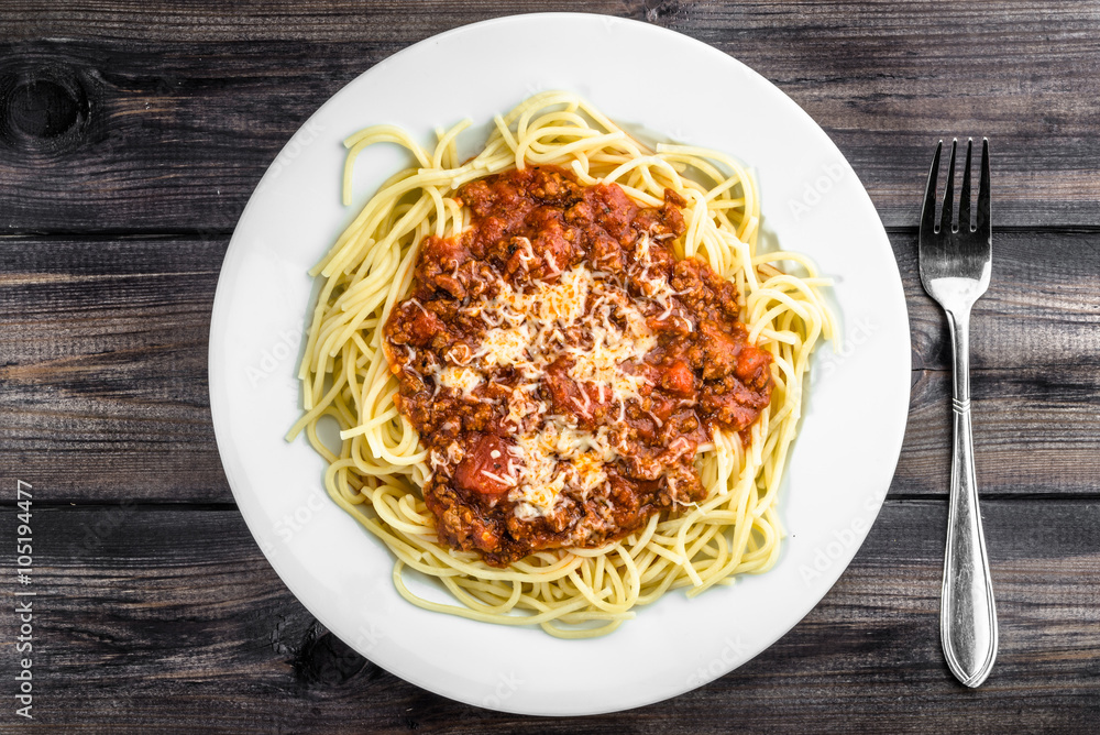 Cooked spaghetti bolognese on white plate.. Cooked spaghetti bolognese on white plate..