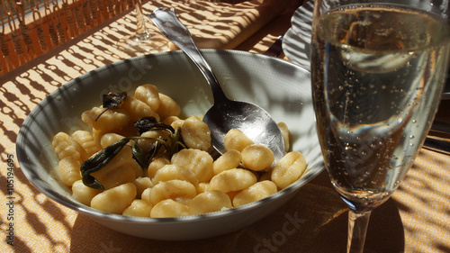 Home made gnocchi pasta lunch with a glass of prosecco, in Italy
