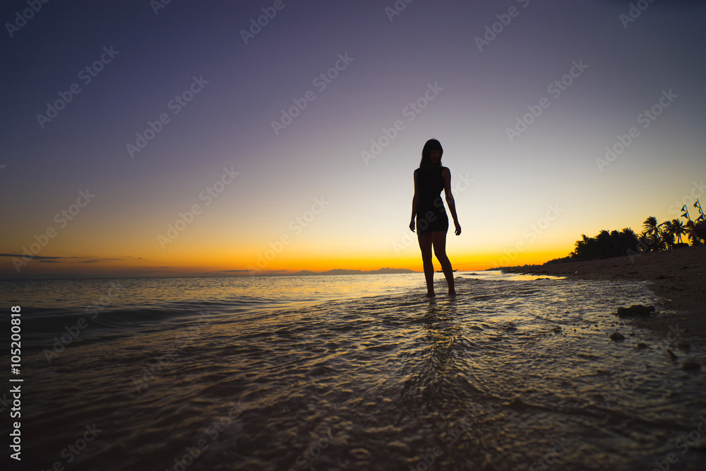 woman relaxing under the sunset at seaside
