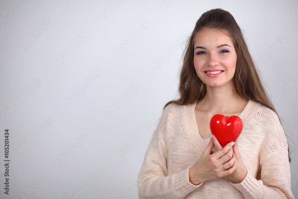 Portrait of beautiful happy woman holding a symbol heart. Portrait of beautiful happy woman holding a symbol heart.