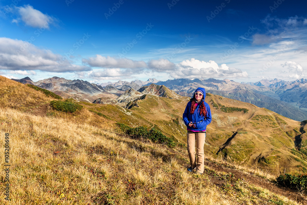 Hiking - hiker woman on trek living healthy active lifestyle. Hiker girl walking on hike in mountain nature landscape in Caucasus mountains, Abkhazia and Russia