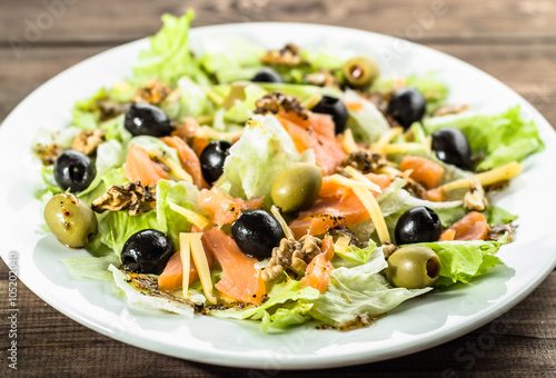 Mediterranean salad with salmon and olives, selective focus