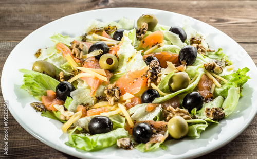 Mediterranean salad with salmon and olives, selective focus