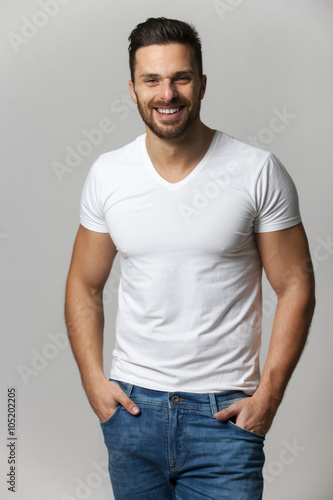 Handsome young man,boy,posing in white t shirt and jeans with ha