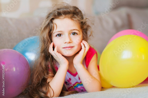 Little girl with multicolored air balloons