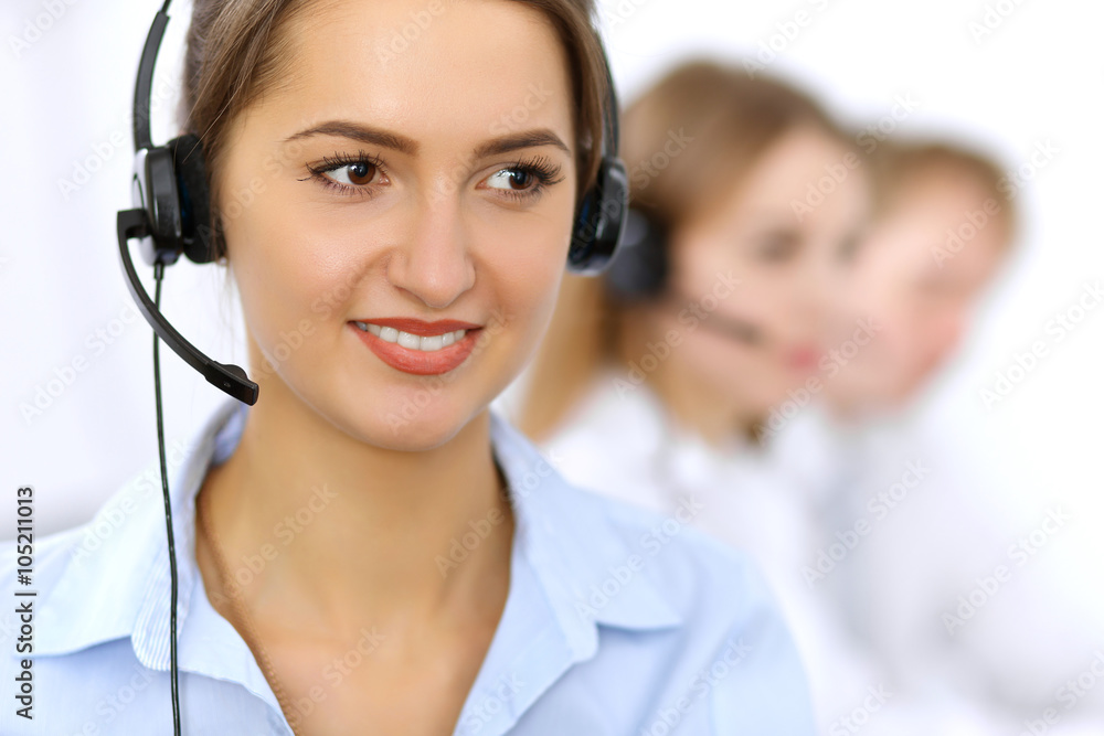 Call center. Focus on beautiful woman in headset Call center. Focus on beautiful woman in headset