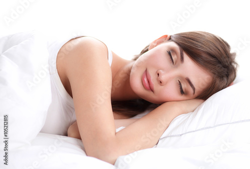 Foto Beautiful girl sleeps in the bedroom, lying on bed