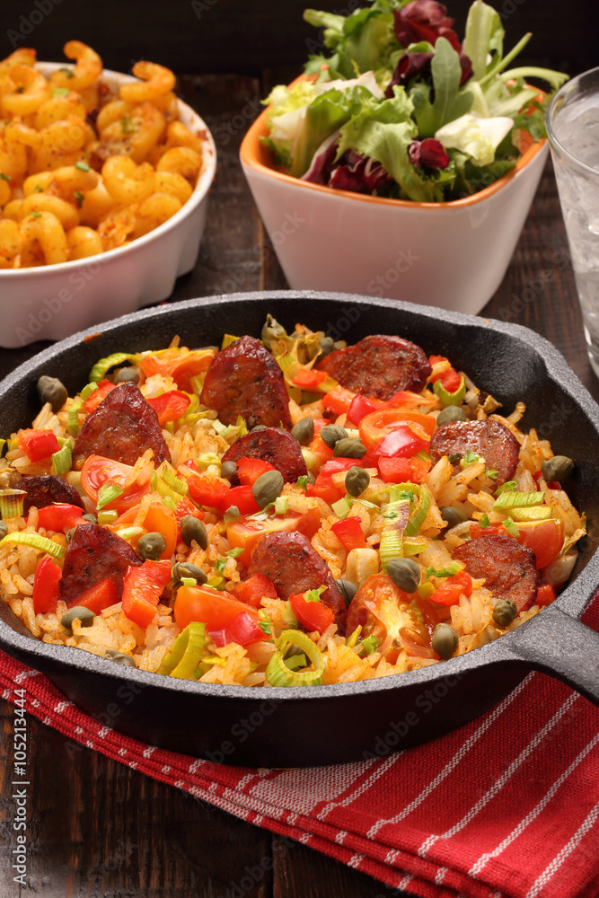 Rice with chorizo sausage and vegetables baked in a pan Rice with chorizo sausage and vegetables baked in a pan