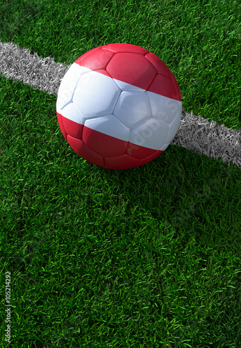 Soccer ball and national flag of Austria, green grass