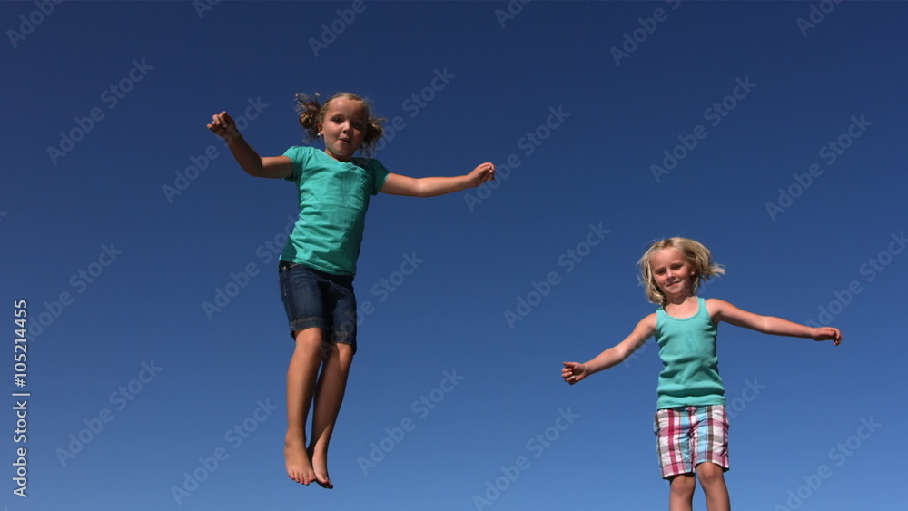 Young girls jumping on trampoline, slow motion Young girls jumping on trampoline, slow motion