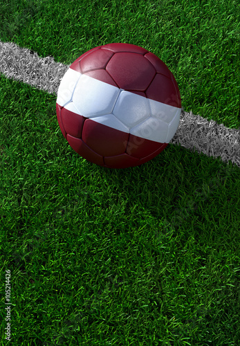 Soccer ball and national flag of Latvia   green grass