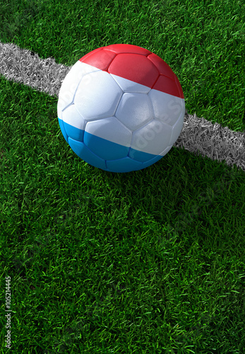 Soccer ball and national flag of Luxembourg, green grass