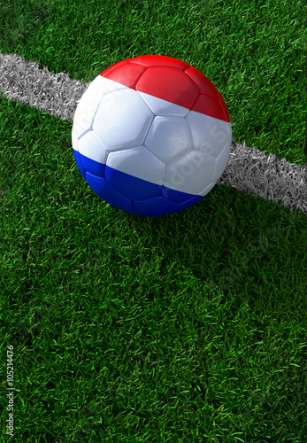 Soccer ball and national flag of Nederland, green grass