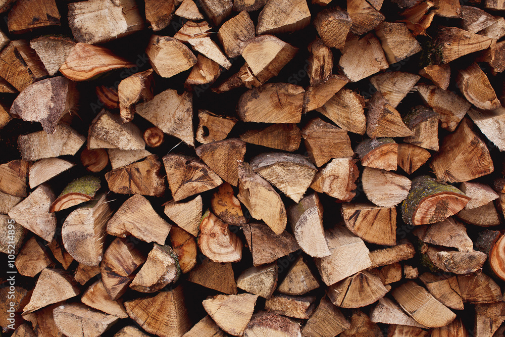 Background of dry chopped firewood logs in a pile Background of dry chopped firewood logs in a pile