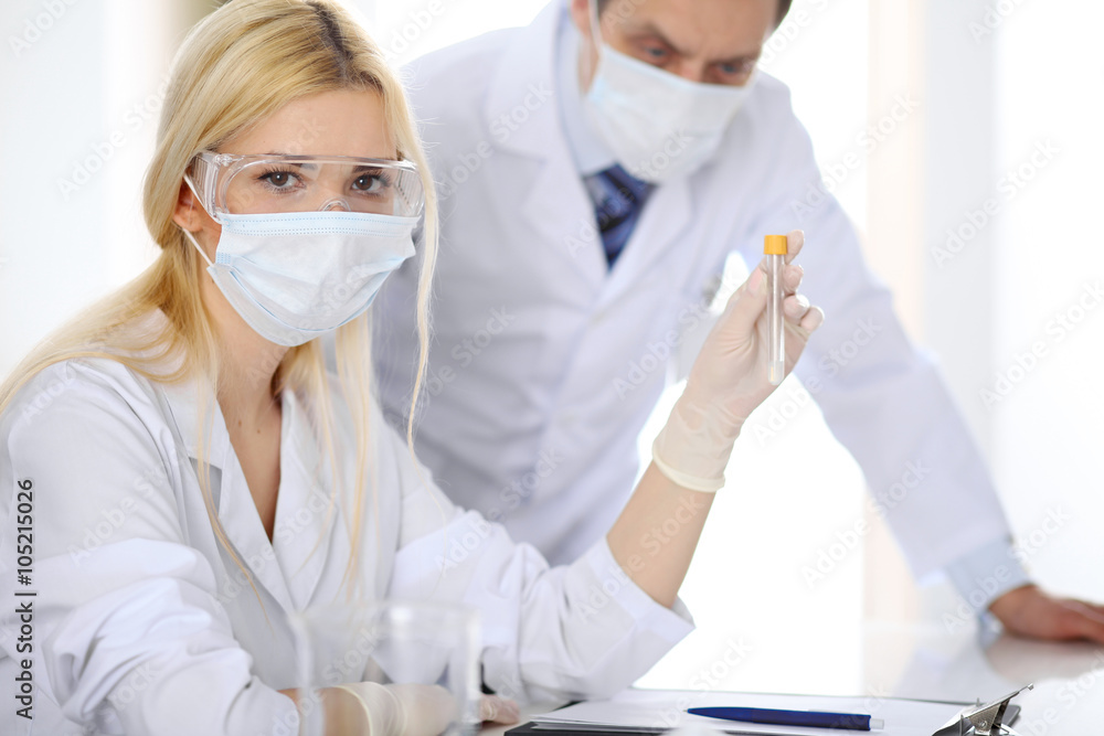 Scientific research team with clear solution in laboratory Scientific research team with clear solution in laboratory
