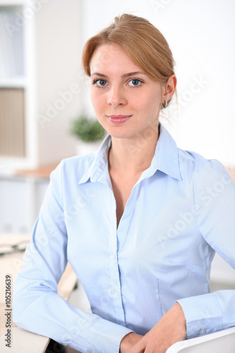 Young blonde business woman with laptop in the office. Business concept.