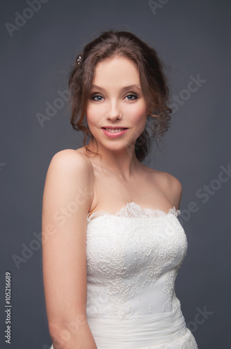 Happy smiling bride wearing white wedding lace dress