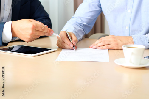 two colleagues is signing a contract, business meeting in the of