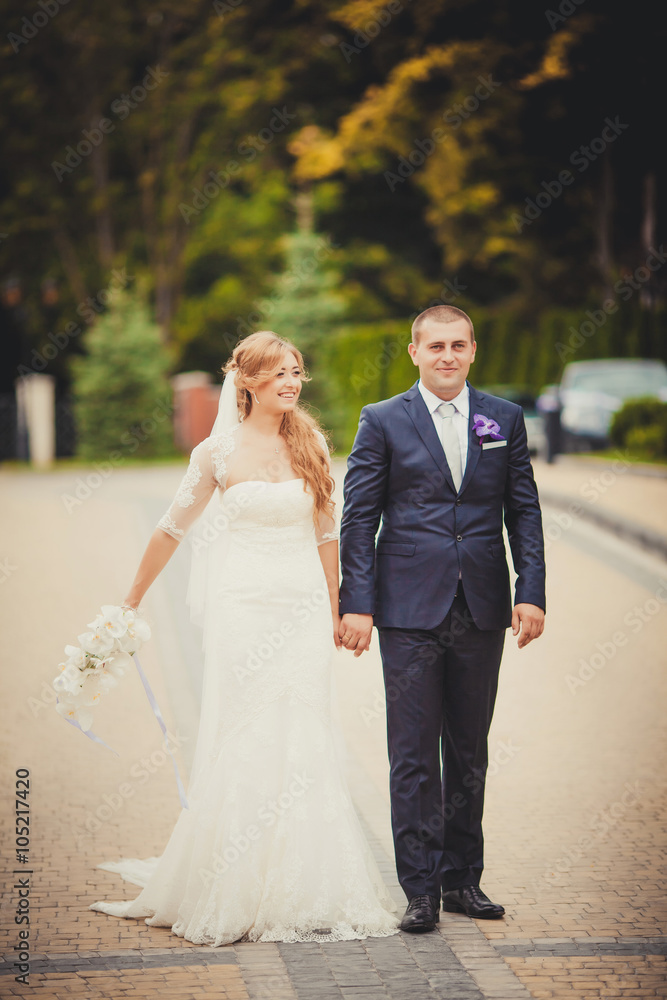 Bride and groom at wedding Day walking Outdoors on spring nature Bride and groom at wedding Day walking Outdoors on spring nature