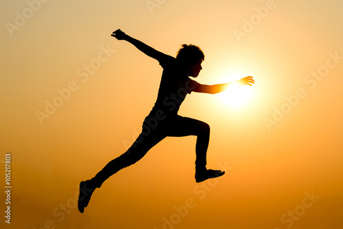 silhouette of a jumping man against the sunset