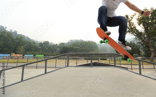 young skateboarder skateboarding at skatepark