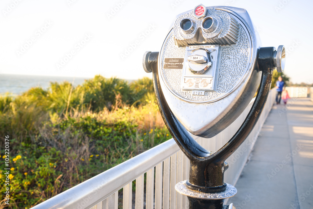 Coin Binoculars on the top over the beach view Coin Binoculars on the top over the beach view