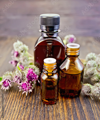 Oil with burdock in bottled on board