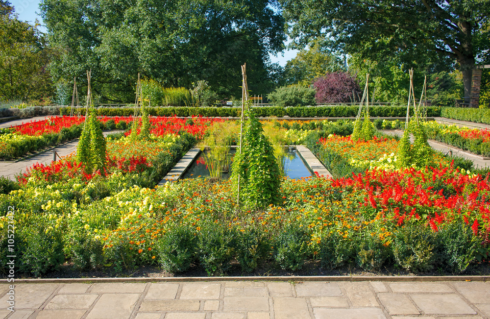 Fototapeta premium Colorful Flower Garden with Paths and Pond