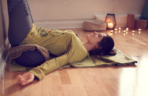 Print op canvas Attractive mixed race woman doing restorative yoga