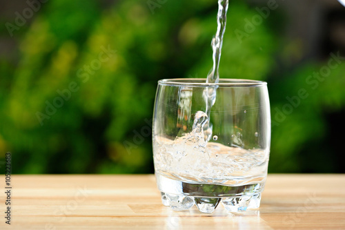 pouring water in whisky glass