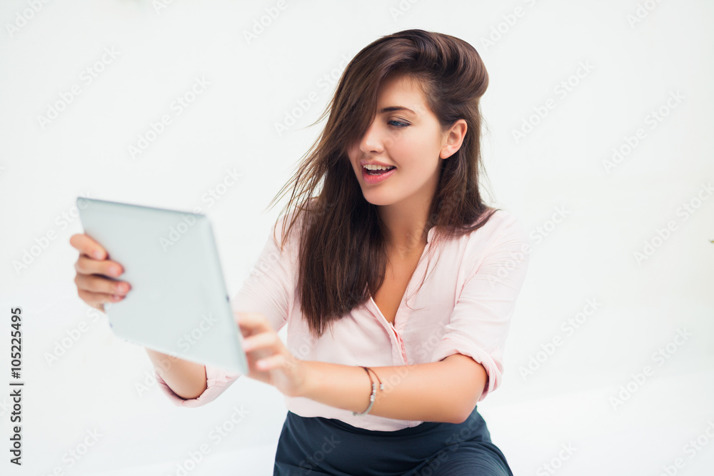 beautiful young woman in sunglasses sitting in a cafe drinking coffee/tea and work on your tablet on the Internet beautiful young woman in sunglasses sitting in a cafe drinking coffee/tea and work on your tablet on the Internet