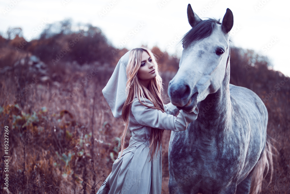 Fototapeta beauty blondie with horse in the field, effect of toning