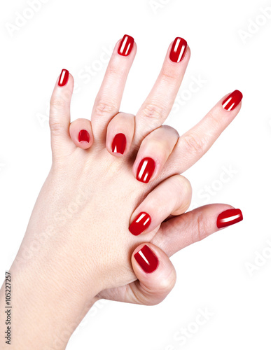 Tela woman's hands with red nail polish
