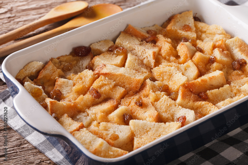 Freshly baked bread pudding with raisins close up in baking dish. horizontal
Freshly baked bread pudding with raisins close up in baking dish. horizontal