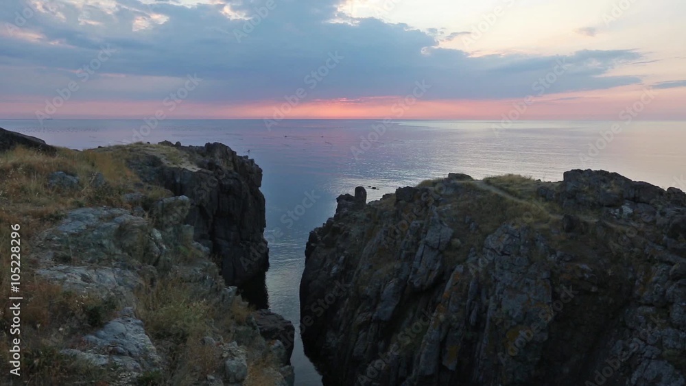 The sky illuminated by rising sun and seascape from rocky cliff.
The sky illuminated by rising sun and seascape from rocky cliff.