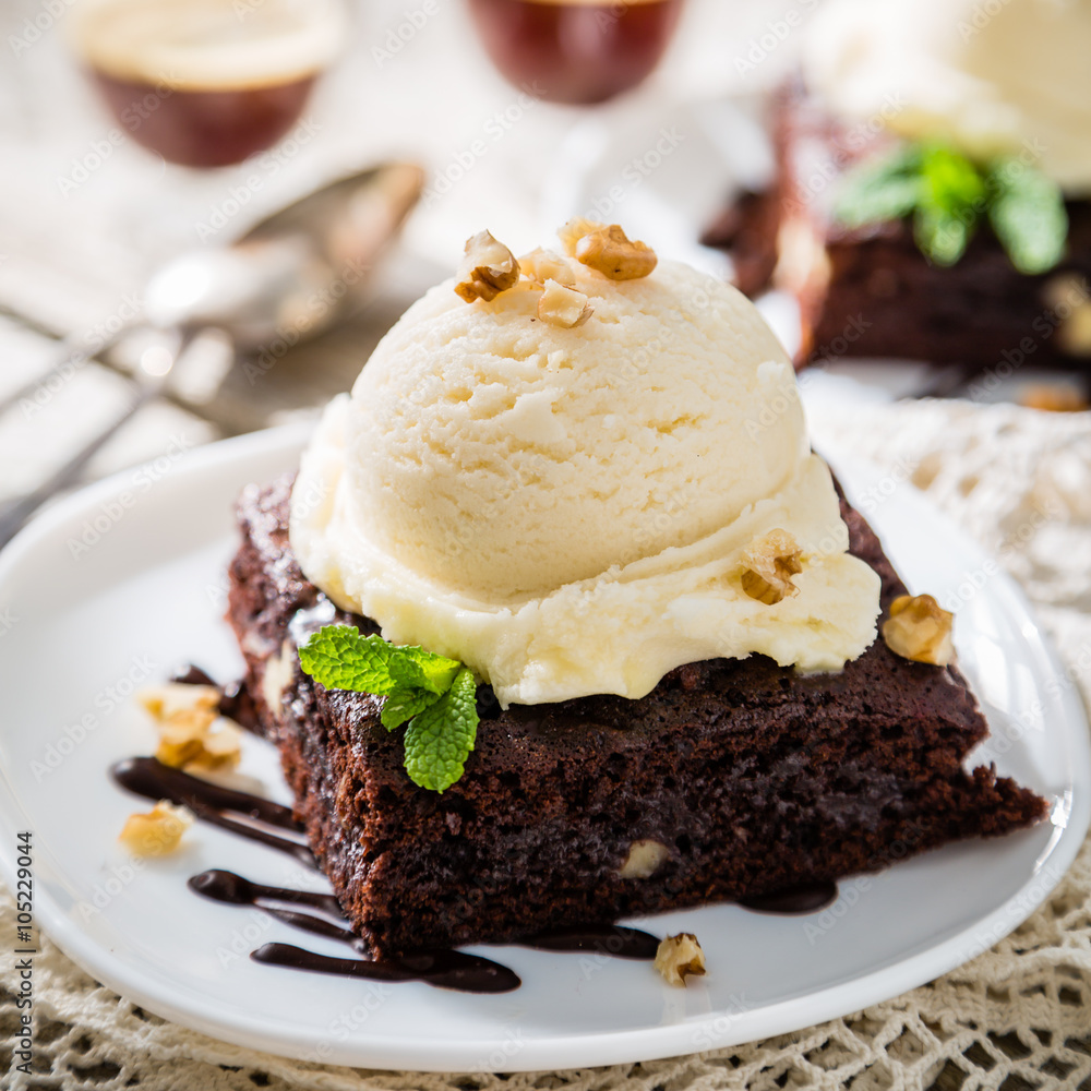 Chocolate brownie with vanilla ice cream, nuts and mint