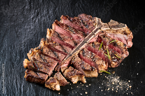 Grilled medium rare t-bone steak with seasoning photo
