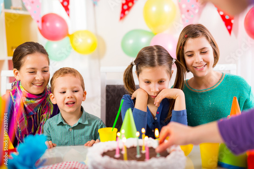 Group of adorable kids having fun at birthday party, selectiv focus